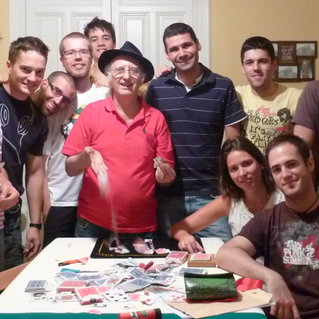 Juan Tamariz con los tres magos de Magia Majara y otros alumnos alrededor de una mesa llena de cartas, en casa de Ana Tamariz